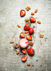 Fototapeta na wymiar Strawberry smoothie with milk and nuts.