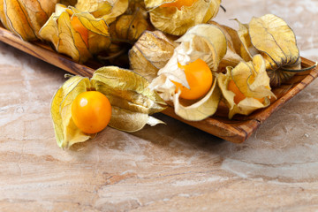 Physalis in wooden dish