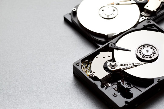 Two hard disks on silver background