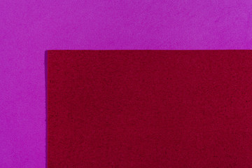 Fototapeta premium Eva foam ethylene vinyl acetate sponge plush red surface on pink smooth background
