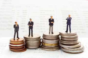 Business people over money background , miniature people business man concept