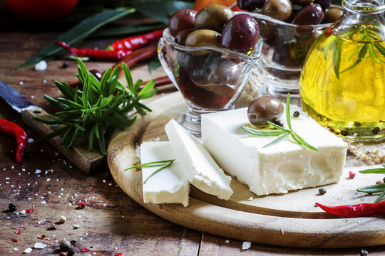 Soft greek feta cheese with rosemary, olives and butter, selecti