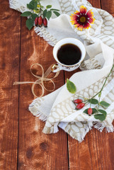 cup of coffee and autumn flowers on a wooden table