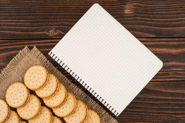 Cookies with a notebook on an old wooden table