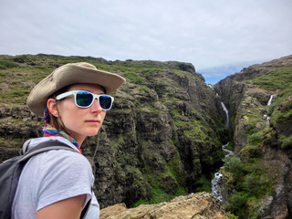 Woman hiking along Icelandic canyon