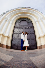Naklejka premium The bride and groom standing next to the large iron gates