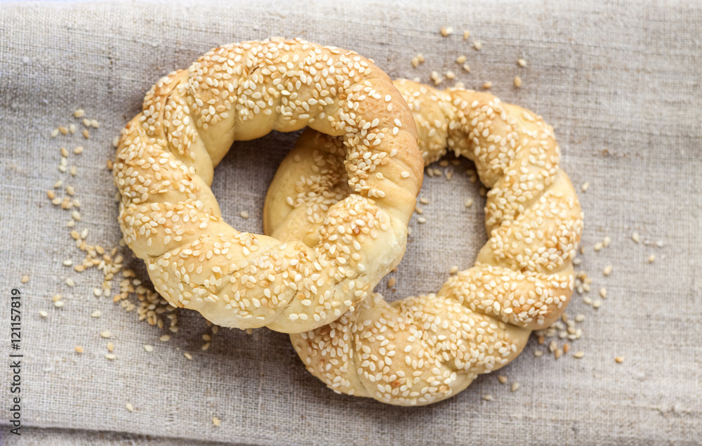 Wall mural two homemade bagels with sesame on a gray canvas