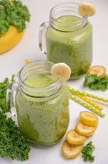 Fresh smoothie with kale and banana on white background, selective focus