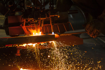 Metal cutting with acetylene torch close-up on low light