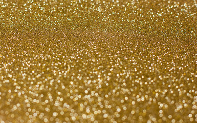 Golden background of blurred glitter