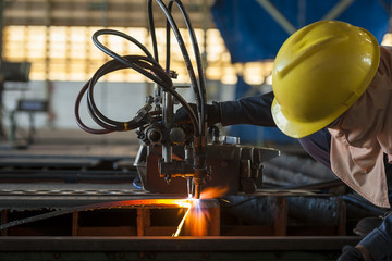 Metal cutting with acetylene torch in factory