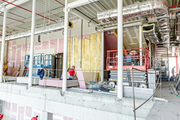 Scissor lift platform parked on a construction, architecture con