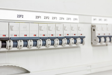 Electrical panel has automatic fuse switches, close up.