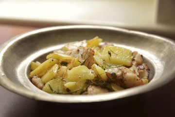 Zander fillet served with fresh potatoes on old plate