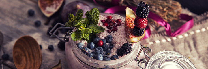 bright detox smoothie with berries on wooden background bowl