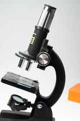 Black microscope on a white background.