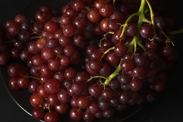 purple grapes still life on black background