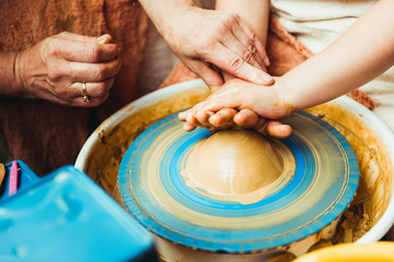 child working on potter's wheel