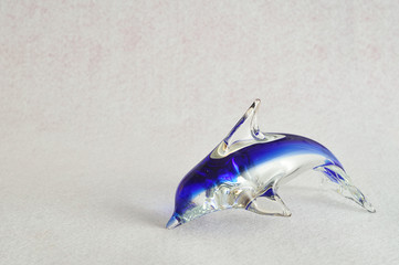 A glass dolphin figurine that is sold for souvenirs 