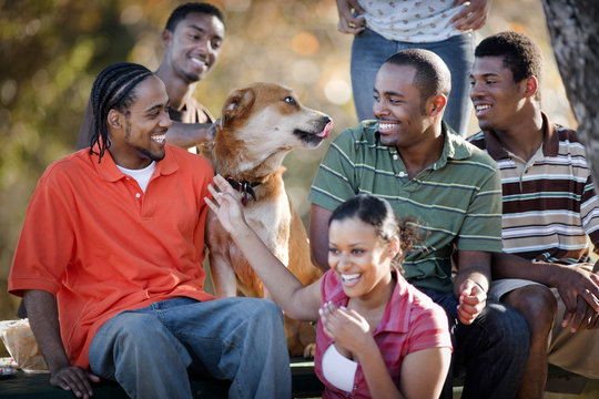 People sitting and laughing with dog
