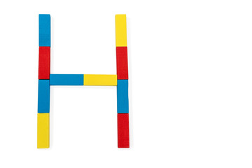 Letter H is folded of wooden blocks
