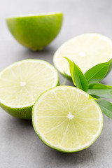 Juicy ripe lime an gray table.