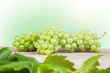 grapes, white wine on a wooden table