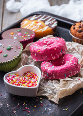 Colorful donuts on a grunge rusty table