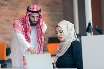 Arabic business couple working together on project at modern startup office