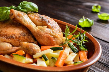 Roasted chicken breasts and legs garnished with parsley, carrot and celery