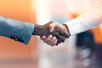 Handshake between african and a caucasian man