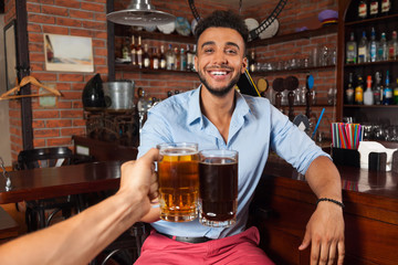 Hispanic Man In Bar Clink Glasses Toasting, Drinking Beer Hold Mugs, Cheerful Friends Meeting