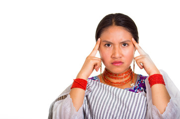 Headshot beautiful young woman wearing traditional andean shawl and red necklace, posing for camera...