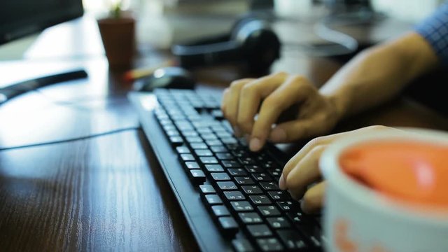 Hands typing on keyboard