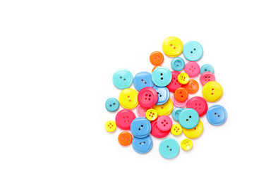 Colorful buttons stacked together on a white background