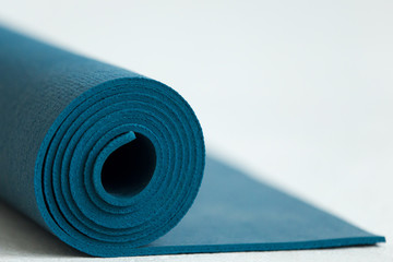 Blue yoga mat © fizkes