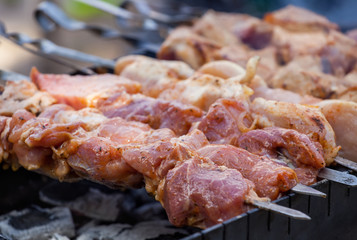Marinated in spices cut into pieces and put on a skewer pork roasted on coals. Preparation of meat products on the grill and barbecue.