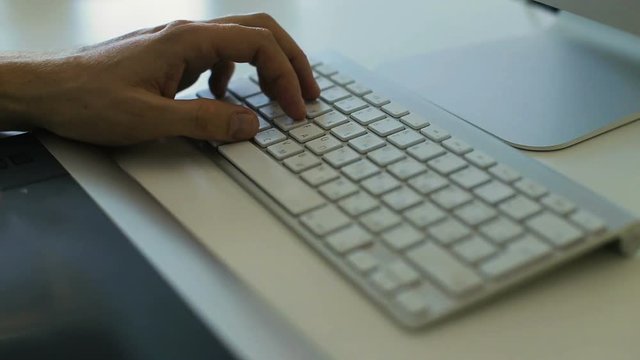 Hands typing on keyboard