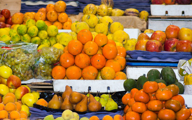 Colorful selection of different fresh delicious fruits and vegetables spread out, blurry effect