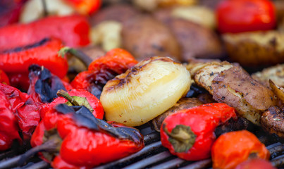 Red bell peppers potatoes mushrooms tomatoes and eggplant grilled until golden brown. The concept of proper nutrition and a healthy lifestyle. Cooking vegetables on the barbecue.