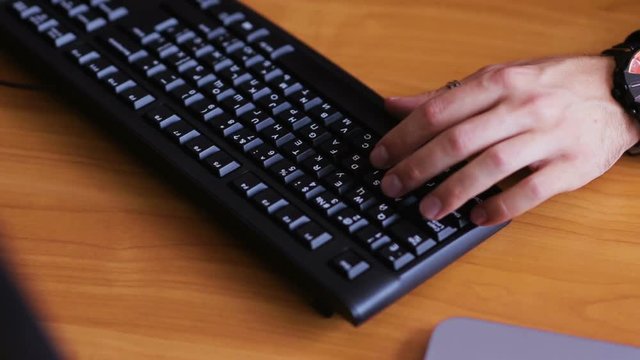 Hands typing on keyboard