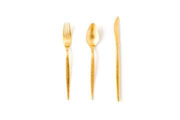 golden fork, spoon, knife isolated on white. flat lay, top view