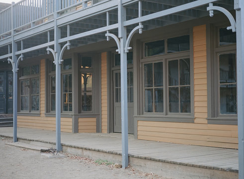 Dilapidated Building With Wooden Sidewalks And Dirt Street From The Old West