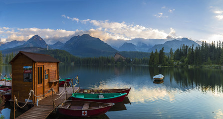 Boat on the dock surrounded mountains. Strbske Pleso High Tatras. Slovakia, Europe.