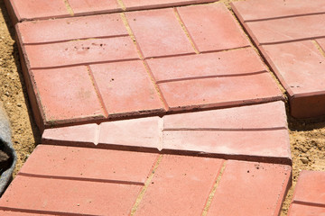 unfinished building path of red concrete tiles