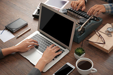 Old typewriter and laptop, concept of technology progress