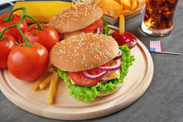 Hamburgers on a wooden plate