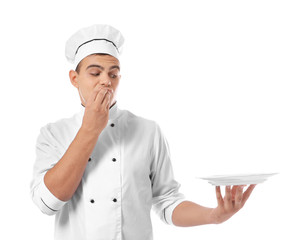 Young handsome chef cook with plate isolated on white