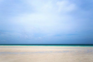 Fototapeta na wymiar Caribbean beach with white sand coastline and deep blue sea, Nassau, Bahamas. Amazing lonely beach with a typical tropical cloudy day.