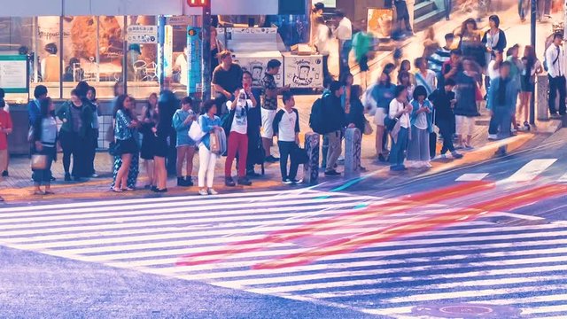 Time lapse of people and vehicles crossing the famous Shibuya intersection in Tokyo Japan